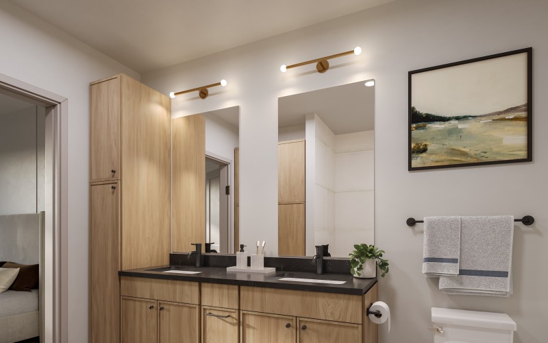 bathroom with mirrors sinks and toilet